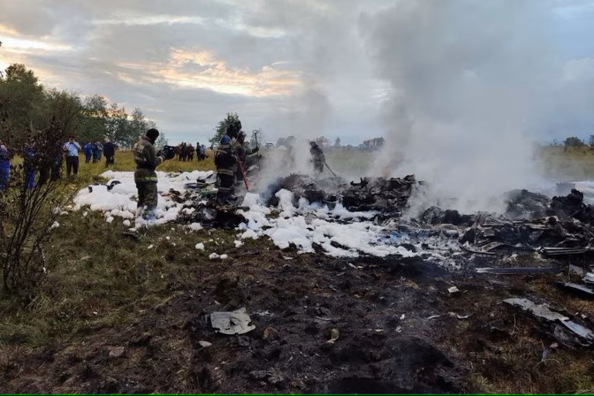 Firefighters work at the scene of the crash site.